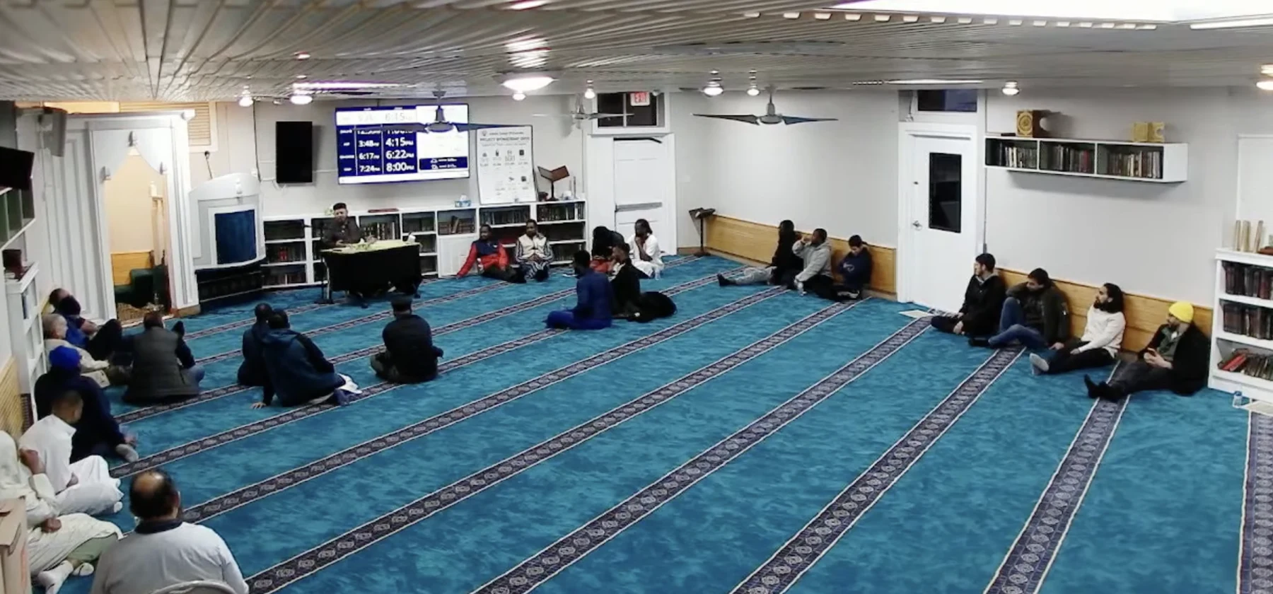 Community members attending a lecture in the prayer hall